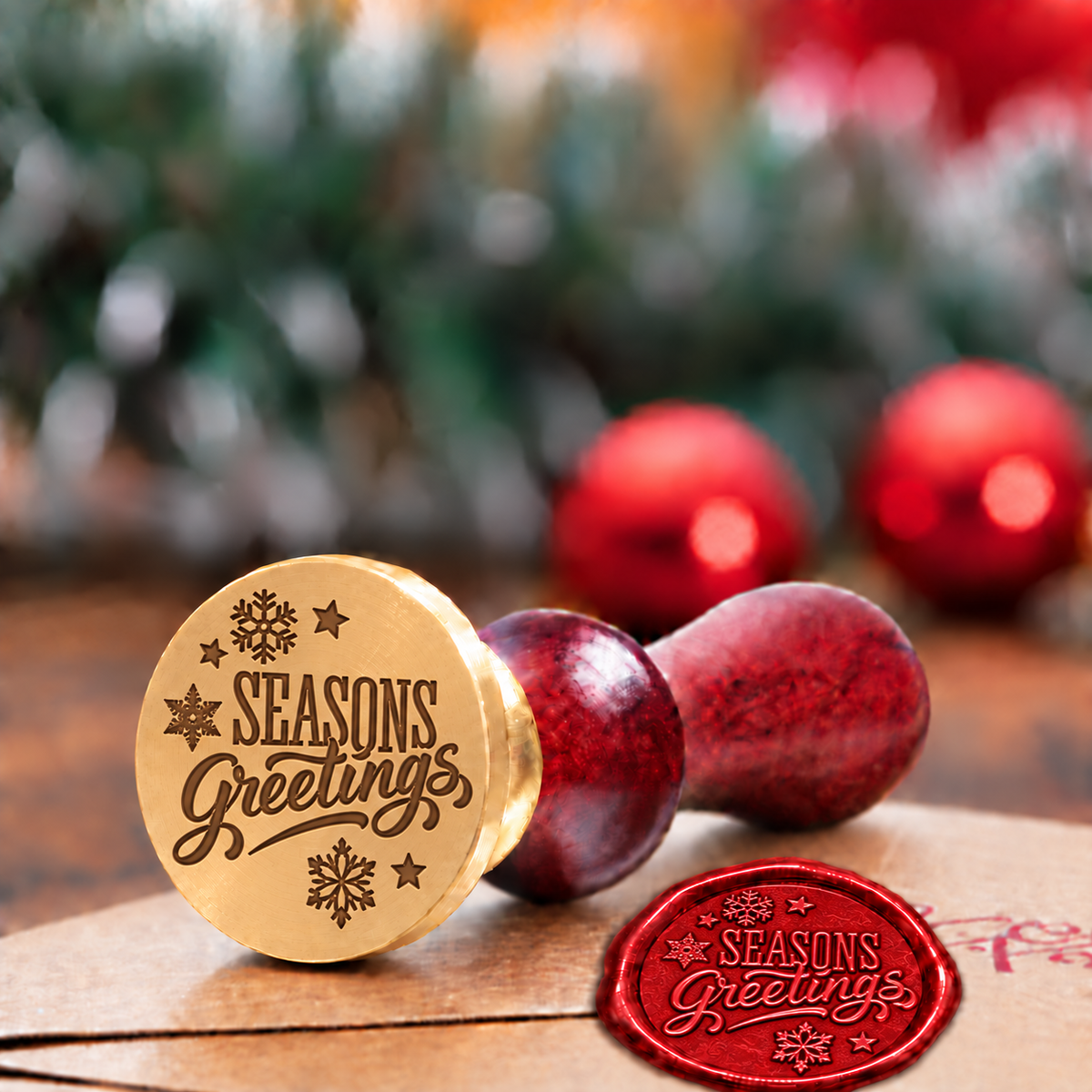 Seasons Greetings wax seal stamp with a burgundy wood handle"